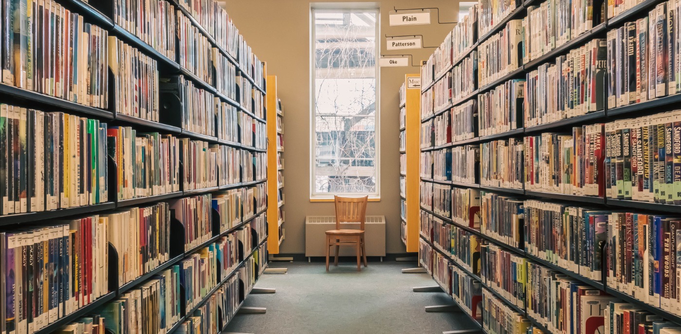 Library stacks with a window in the background